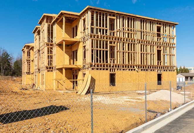 a close-up of temporary chain link fences enclosing a construction site, signaling progress in the project's development in Inglewood CA